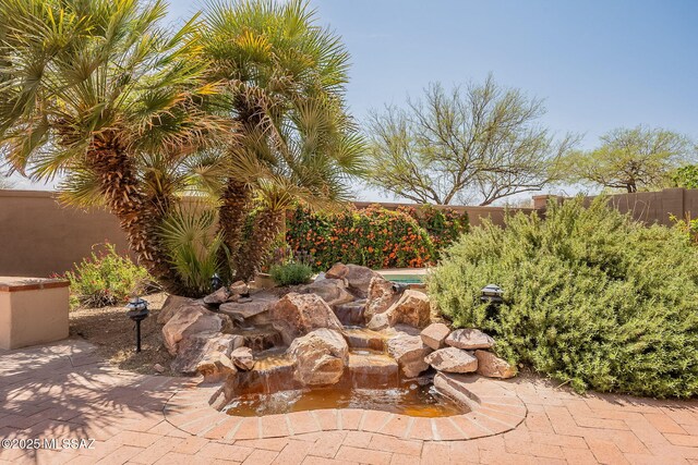 434 E Via Puente De La Lluvia, Sahuarita, AZ 85629 - view of patio with a fenced backyard and a garden pond