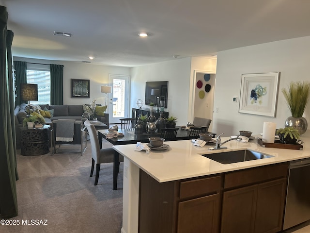 22138 E Arcus Pl, Red Rock, AZ 85145 - kitchen featuring a sink, stainless steel dishwasher, light countertops, carpet flooring, and open floor plan
