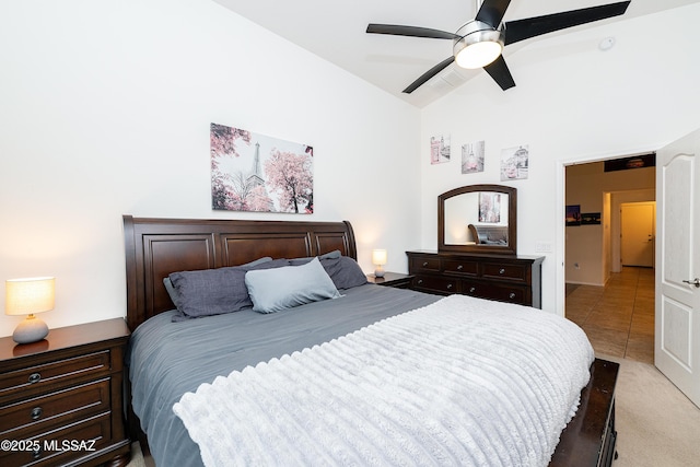 61080 Halter Pl, Saddlebrooke, AZ 85739 - bedroom featuring light tile patterned flooring, high vaulted ceiling, visible vents, a ceiling fan, and light carpet