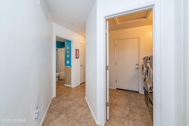 61080 Halter Pl, Saddlebrooke, AZ 85739 - hallway with independent washer and dryer, light tile patterned floors, attic access, and visible vents
