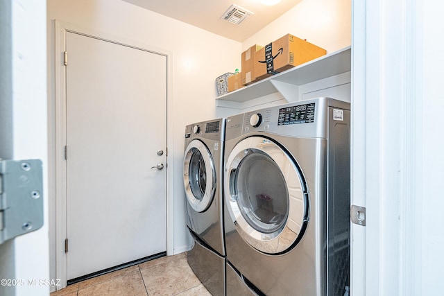 61080 Halter Pl, Saddlebrooke, AZ 85739 - laundry area featuring light tile patterned floors, washing machine and dryer, laundry area, and visible vents