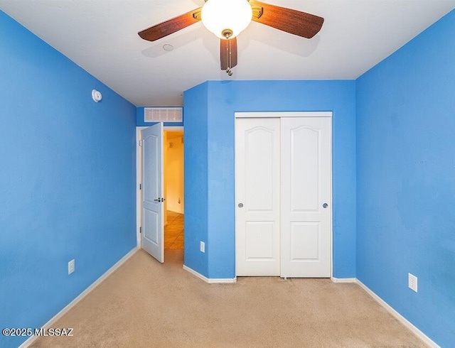 61080 Halter Pl, Saddlebrooke, AZ 85739 - unfurnished bedroom featuring a closet, visible vents, carpet, baseboards, and a ceiling fan