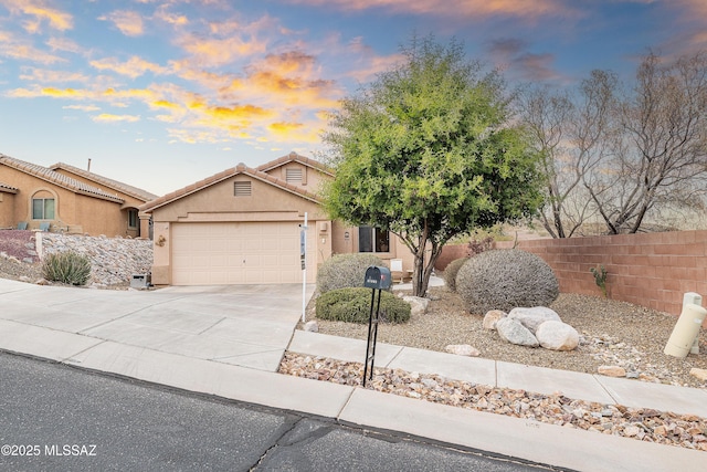 61080 Halter Pl, Saddlebrooke, AZ 85739 - view of front of house with driveway, stucco siding, fence, a tiled roof, and a garage