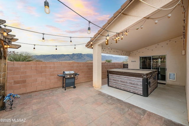 61080 Halter Pl, Saddlebrooke, AZ 85739 - patio terrace at dusk featuring a grill, fence, and a hot tub