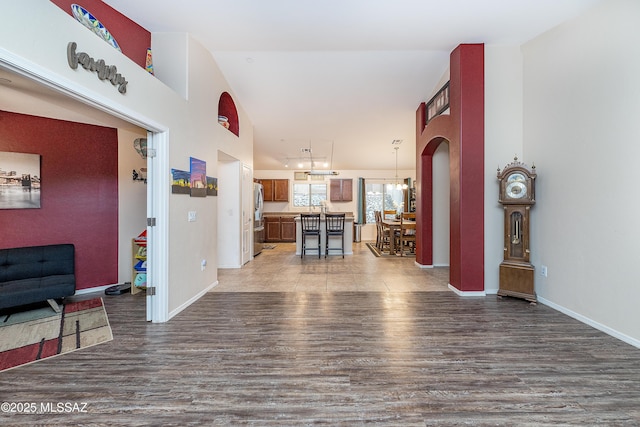 61080 Halter Pl, Saddlebrooke, AZ 85739 - living room with baseboards, wood finished floors, and an inviting chandelier