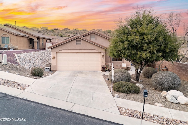 61080 Halter Pl, Saddlebrooke, AZ 85739 - view of front of house featuring fence, driveway, stucco siding, and a garage