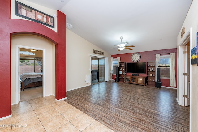 61080 Halter Pl, Saddlebrooke, AZ 85739 - living room with lofted ceiling, visible vents, wood finished floors, and a ceiling fan