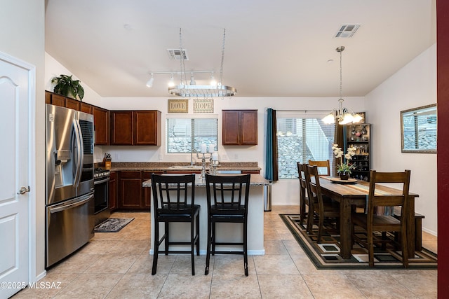 61080 Halter Pl, Saddlebrooke, AZ 85739 - kitchen with an inviting chandelier, vaulted ceiling, stainless steel appliances, and dark brown cabinetry