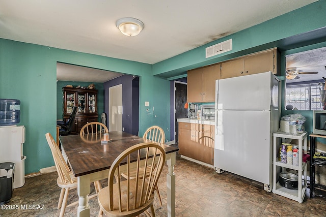 dining area with baseboards, ceiling fan, and visible vents