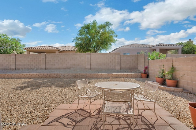 view of patio featuring a fenced backyard and outdoor dining space