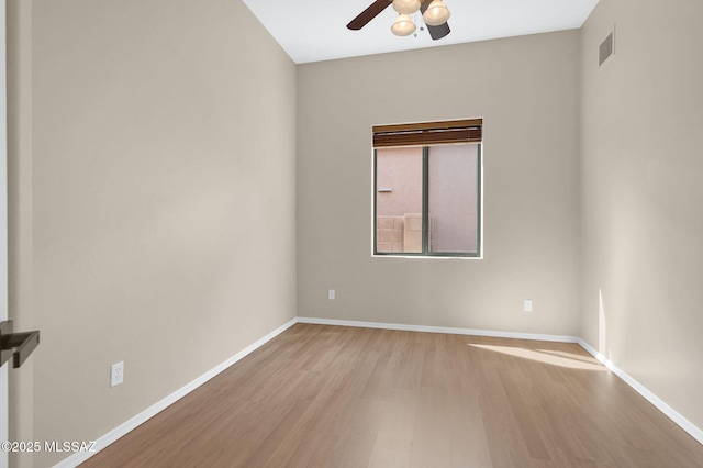 unfurnished room featuring wood finished floors, visible vents, baseboards, and ceiling fan