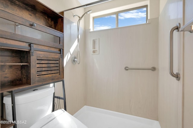 bathroom featuring toilet and a stall shower