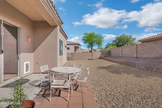 view of patio with outdoor dining space and a fenced backyard