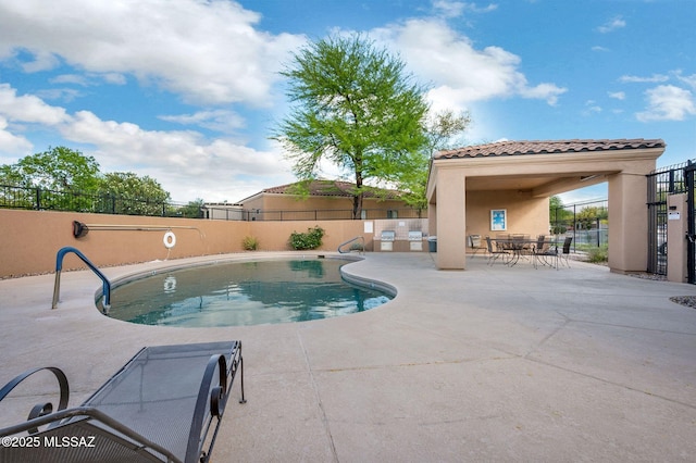 pool featuring a patio and fence