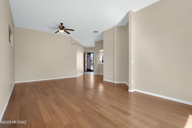spare room featuring ceiling fan, baseboards, and light wood-style floors