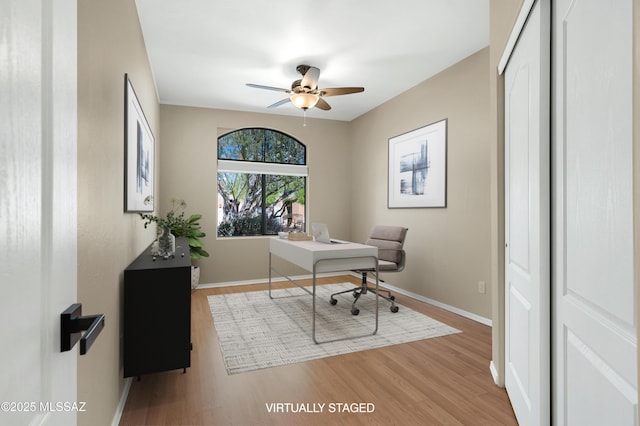 office featuring ceiling fan, baseboards, and wood finished floors