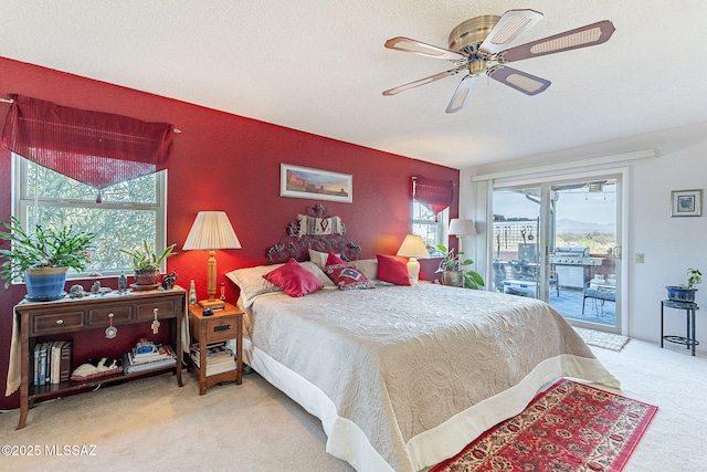 bedroom featuring carpet flooring, a textured ceiling, access to outside, and a ceiling fan