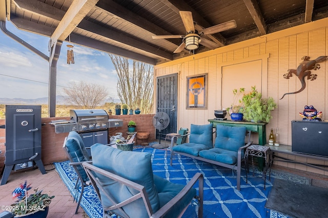 view of patio / terrace with an outdoor living space, area for grilling, and a ceiling fan