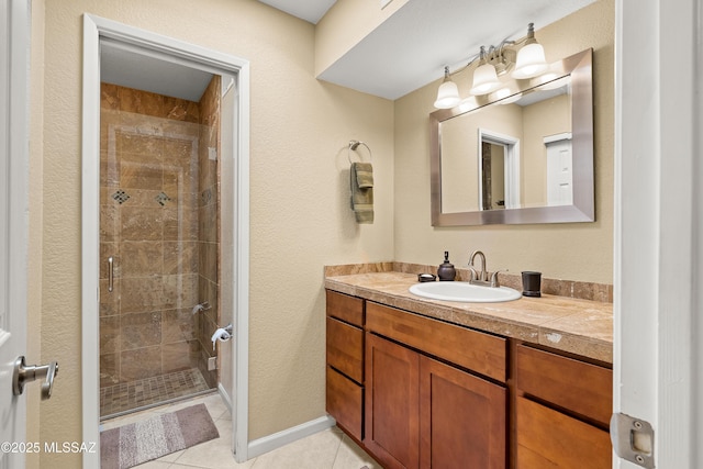 bathroom with a shower stall, tile patterned flooring, and vanity