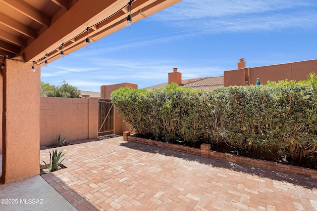 view of patio with fence and a gate