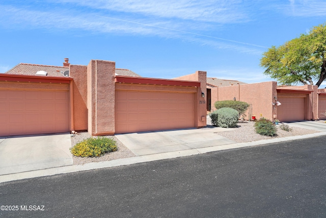 southwest-style home with stucco siding and driveway