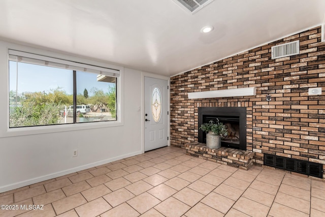 5914 E Beverly St, Tucson, AZ 85711 - unfurnished living room featuring baseboards, a brick fireplace, recessed lighting, and visible vents