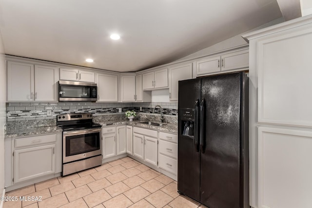 5914 E Beverly St, Tucson, AZ 85711 - kitchen featuring tasteful backsplash, light stone counters, a sink, light tile patterned floors, and stainless steel appliances