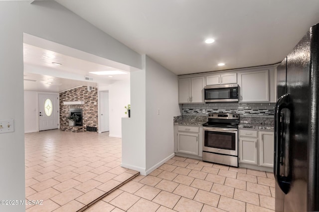 5914 E Beverly St, Tucson, AZ 85711 - kitchen with baseboards, open floor plan, tasteful backsplash, appliances with stainless steel finishes, and light tile patterned floors