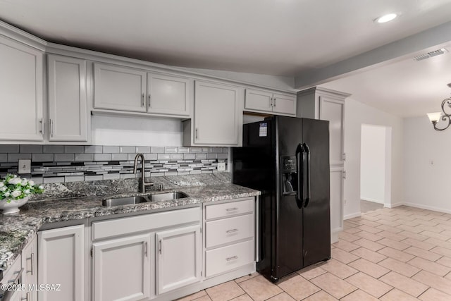 5914 E Beverly St, Tucson, AZ 85711 - kitchen featuring lofted ceiling with beams, a sink, decorative backsplash, visible vents, and black fridge with ice dispenser