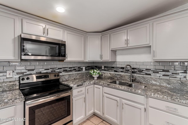 5914 E Beverly St, Tucson, AZ 85711 - kitchen with stainless steel appliances, stone counters, a sink, and tasteful backsplash