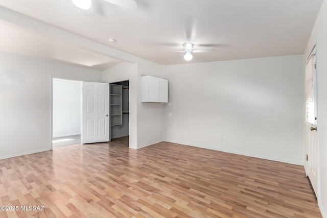 5914 E Beverly St, Tucson, AZ 85711 - unfurnished bedroom featuring a ceiling fan, baseboards, and light wood-style floors