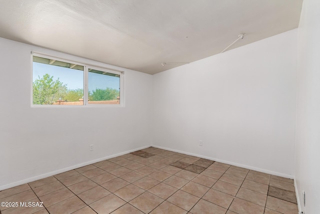 5914 E Beverly St, Tucson, AZ 85711 - empty room with baseboards and light tile patterned floors