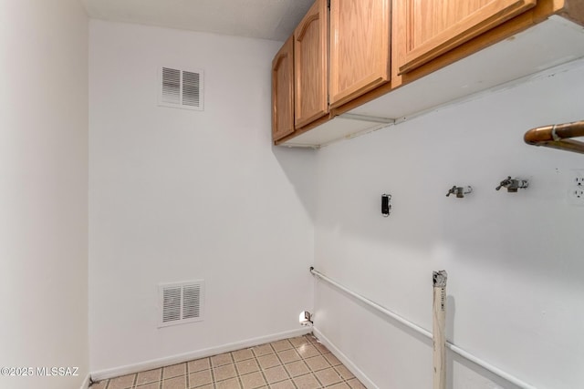5914 E Beverly St, Tucson, AZ 85711 - clothes washing area featuring light tile patterned floors, baseboards, cabinet space, and visible vents