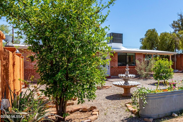 5914 E Beverly St, Tucson, AZ 85711 - exterior space with brick siding, central AC unit, and fence