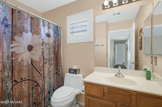 bathroom featuring vanity, a shower with shower curtain, toilet, and visible vents
