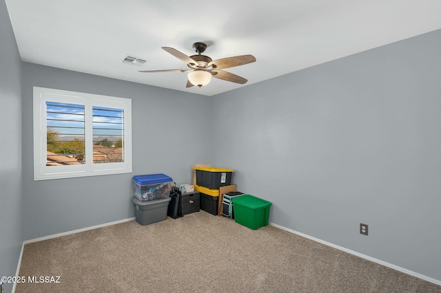game room with carpet floors, ceiling fan, visible vents, and baseboards