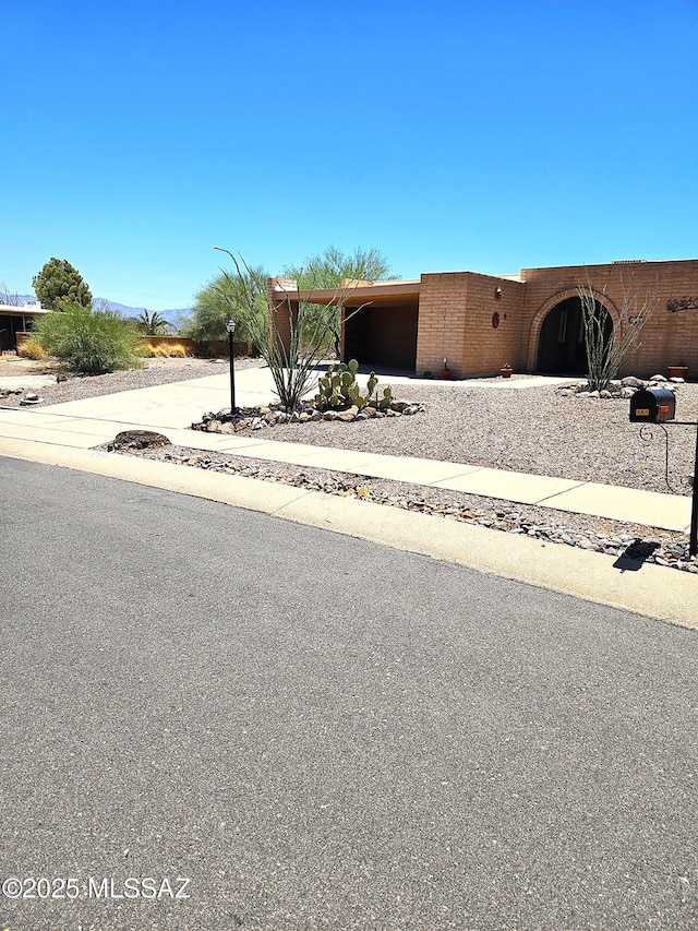 341 W Rio-Santa Cruz, Green Valley, AZ 85614 - view of front of house featuring driveway and a garage