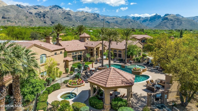 7050 E Sunrise Dr Unit 1104, Tucson, AZ 85750 - view of pool featuring a gazebo, an in-ground hot tub, and a mountain view