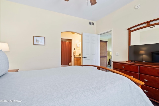 7050 E Sunrise Dr Unit 1104, Tucson, AZ 85750 - bedroom with arched walkways, ensuite bath, and ceiling fan