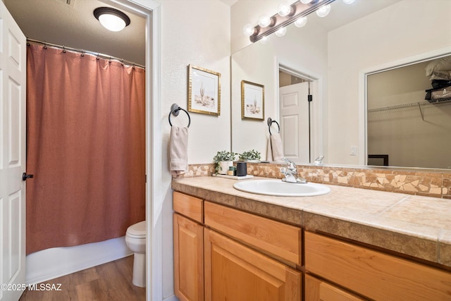 7050 E Sunrise Dr Unit 1104, Tucson, AZ 85750 - full bathroom featuring vanity, toilet, and wood finished floors