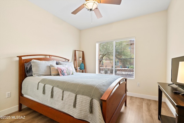 7050 E Sunrise Dr Unit 1104, Tucson, AZ 85750 - bedroom with wood finished floors, baseboards, and a ceiling fan