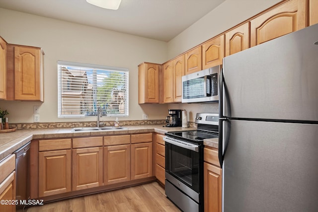 7050 E Sunrise Dr Unit 1104, Tucson, AZ 85750 - kitchen featuring stainless steel appliances, a sink, light wood finished floors, and light brown cabinets