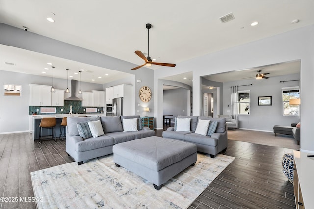 7415 W Cactus Flower Pass, Marana, AZ 85658 - living room featuring ceiling fan, arched walkways, wood finished floors, and recessed lighting