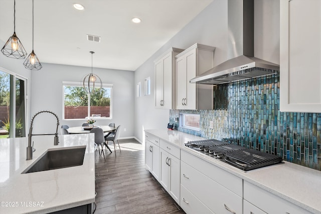 7415 W Cactus Flower Pass, Marana, AZ 85658 - kitchen featuring wall chimney exhaust hood, a sink, stainless steel gas cooktop, tasteful backsplash, and white cabinets