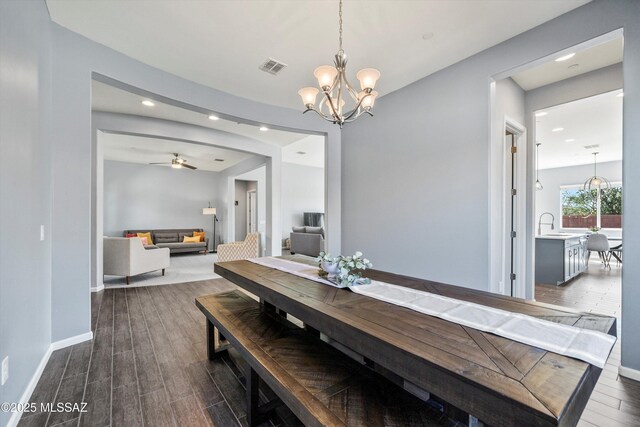 7415 W Cactus Flower Pass, Marana, AZ 85658 - dining space with recessed lighting, dark wood finished floors, ceiling fan, a chandelier, and baseboards