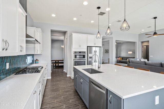 7415 W Cactus Flower Pass, Marana, AZ 85658 - kitchen with appliances with stainless steel finishes, a sink, a ceiling fan, open floor plan, and baseboards