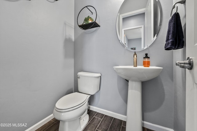 7415 W Cactus Flower Pass, Marana, AZ 85658 - half bathroom with toilet, wood tiled floors, and baseboards