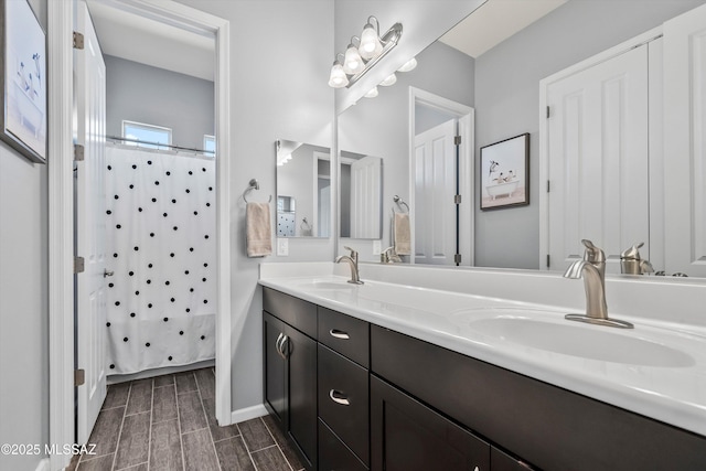 7415 W Cactus Flower Pass, Marana, AZ 85658 - bathroom featuring double vanity, a shower with shower curtain, and baseboards