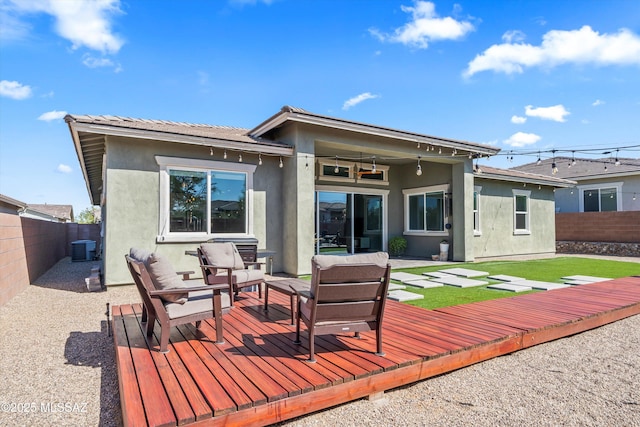 7415 W Cactus Flower Pass, Marana, AZ 85658 - rear view of house with a fenced backyard, stucco siding, a wooden deck, and an outdoor hangout area