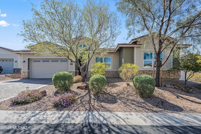 7415 W Cactus Flower Pass, Marana, AZ 85658 - view of front of house featuring stone siding, a garage, and driveway